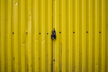 Padlock on Yellow Door . security and safety concept