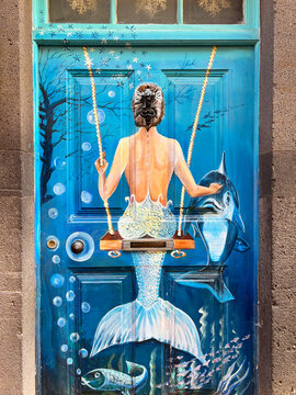 FUNCHAL, MADEIRA/PORTUGAL - 18. December 2021: Mermaid painting at a permanent street art exhibition on doors facing the street in Funchal - Madeira on December 18, 2021.