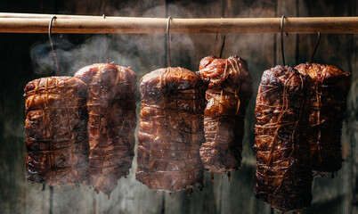 Smoked pork. Traditional method of smoking meat in smok in a homemade smokehouse