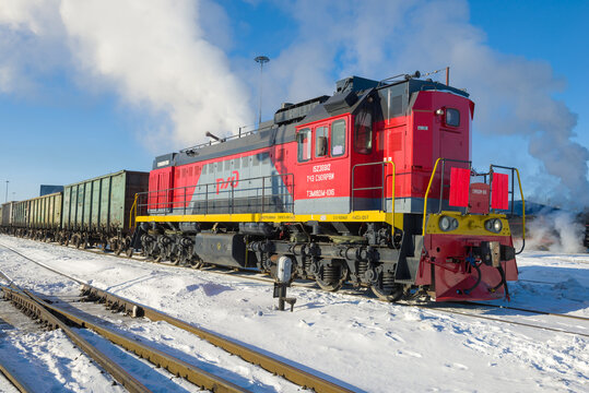 SORTAVALA, RUSSIA - MARCH 10, 2021: Russian shunting diesel locomotive TEM18DM with freight train on the Sortavala station on a sunny March day