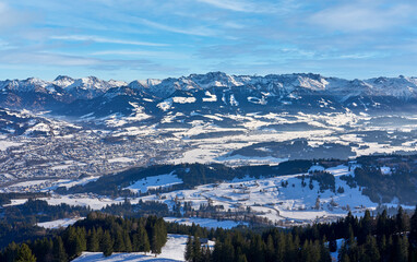 panoramic winter landscape in The Allgaeu Alps high above river Iller valley with sonthofen and Oberstdorf