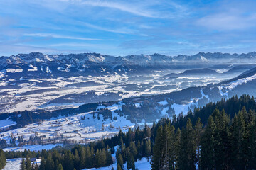 panoramic winter landscape in The Allgaeu Alps high above river Iller valley with sonthofen and Oberstdorf
