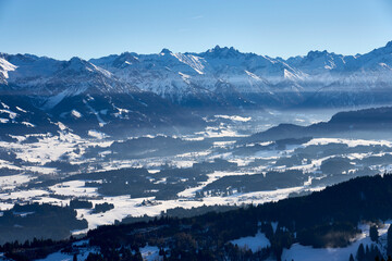 panoramic winter landscape in The Allgaeu Alps high above river Iller valley with sonthofen and Oberstdorf