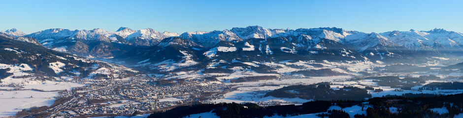 panoramic winter landscape in The Allgaeu Alps high above river Iller valley with sonthofen and Oberstdorf