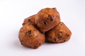 A pile of Dutch traditional oliebollen (New Year's snack) isolated on white background