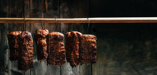 Tasty meats. Traditionally smoked meats pork ham. Traditional method of smoking meat in smoke. Long...