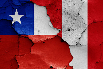 flags of Chile and Peru painted on cracked wall