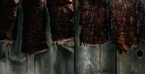 Closeup of freshly smoked ham in smokehouse. Natural product from an organic farm. banner, menu,...