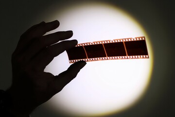 Hand holding 35mm film negatives