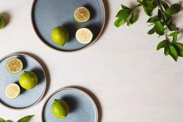 Obraz na płótnie Canvas Lemons on blue plates and wood background - Flat lay