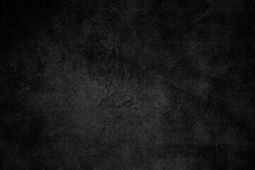 Black concrete plaster wall with rough grunge texture for background