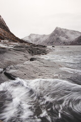 Obraz premium Stormy sea with a view of the Norwegian fjords from the famous tourist spot Tungeneset in the northern part of the Senja peninsula. Scandinavia