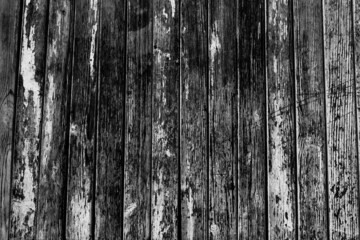 Old shabby wood planks with cracked black and white paint