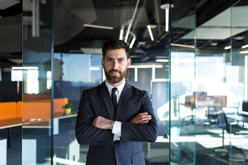 Fototapeta na wymiar Serious and confident, head businessman with arms crossed, looking at camera, in modern office