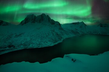 Mountain Segla and sky background with northern lights. Aurora borealis on Senja islands, Norway....