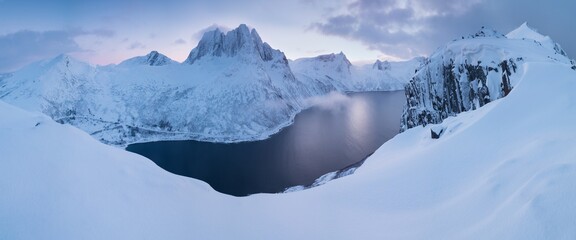 Polar night, Senja panoramic view landscape nordic snow cold winter norway ocean cloudy sky snowy mountains. Troms county, Fjordgard, Mefjorden, Norway 