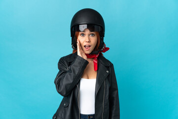 Teenager biker girl isolated on blue background with surprise and shocked facial expression