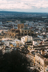 Fototapeta premium The Granada Cathedral in the middle of the city with the Cathedral, seen from the Candle Tower in the Alcabaza