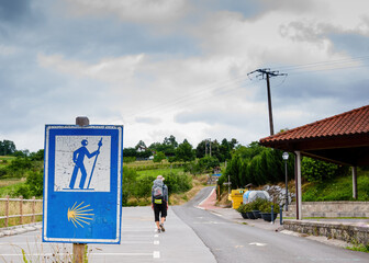 Lonely Pilgrim with backpack walking the Camino de Santiago in Spain, Way of St James