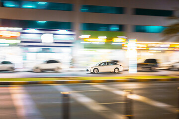 Fototapeta na wymiar Speeding Taxi Car Fast Driving In City Street. Motion Blur Background