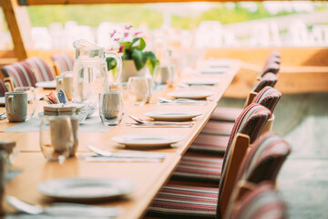Cozy Interior Of Summer Cafe. Table And Cutlery Laid Out