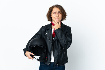 English woman holding a motorcycle helmet isolated on white background having doubts and thinking