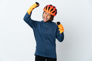 Young English cyclist woman isolated on white background celebrating a victory