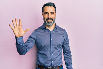 Fototapeta premium Middle age man with beard and grey hair wearing business clothes showing and pointing up with fingers number five while smiling confident and happy.