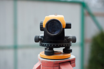 Surveying measuring equipment level transit on tripod at construction building area site