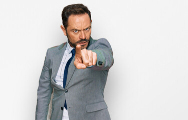 Middle age man wearing business clothes pointing displeased and frustrated to the camera, angry and furious with you
