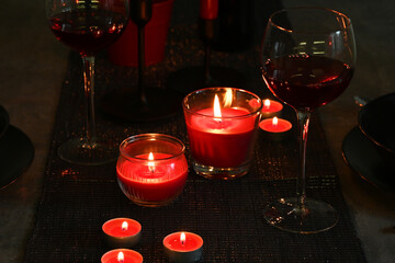 Romantic candlelit dinner and red wine in the dark.