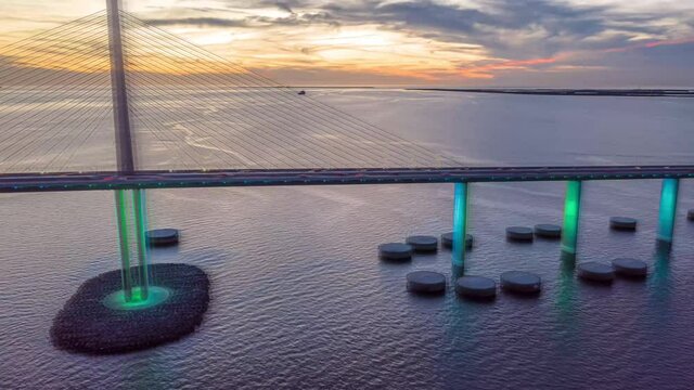 Time-lapse video of colorfully lit Sunshine Skyway Bridge in Florida during sunset
