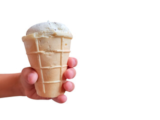 Fresh white ice cream in waffle cup in kid's hand on blue background