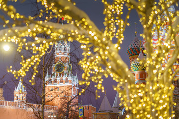 Fototapeta premium view of the Kremlin and the Spasskaya tower through the Christmas illumination, Moscow, Russia