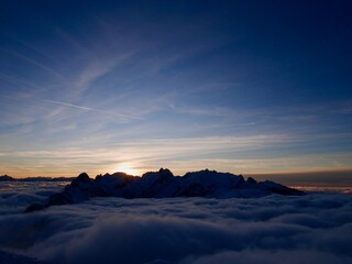 Spectacular view of Alpstein and fog blanket at sunset in winter seen from the mountain station of Hoher Kasten cable car. Appenzell, Switzerland. 