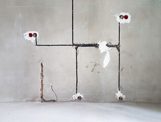 Wiring. Sockets and wires in cement wall - room repair