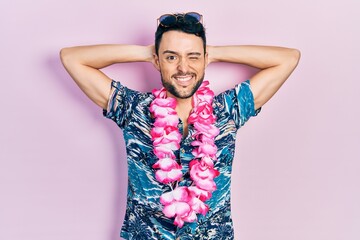 Young hispanic man wearing summer style winking looking at the camera with sexy expression,...