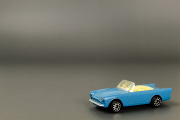 Kinder surprise toys on a gray background. Happy childhood. Toys. Kinder egg. Small car models. Toy cars.