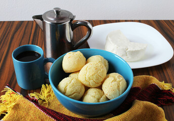 Bowl with brazilian cheese bread, black coffee and white cheese.