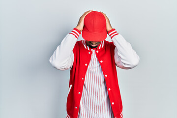 Young african american man wearing baseball uniform suffering from headache desperate and stressed because pain and migraine. hands on head.