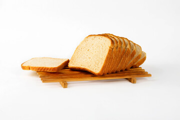 Slicing white wheat bread on a pallet on a white background.