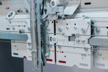 Elevator door opening and closing mechanism at lift exhibition, trade show - close up view. Technology, engineering, machinery, equipment and electronic concept
