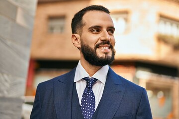 Fototapeta premium Young businessman smiling happy standing at the city.
