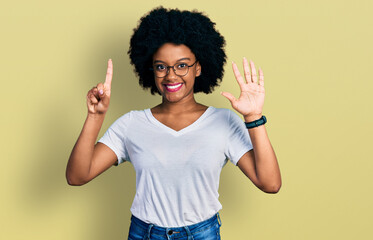 Young african american woman wearing casual white t shirt showing and pointing up with fingers number six while smiling confident and happy.