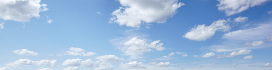 Naklejka na ściany i meble Panoramic photo of blurred sky. Blue sky background with cumulus clouds