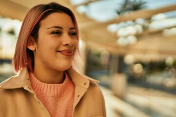 Young hispanic girl smiling happy standing at the city.