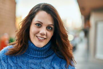 Young irish plus size girl smiling happy standing at the city.