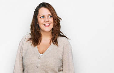 Young plus size woman wearing casual clothes looking away to side with smile on face, natural expression. laughing confident.