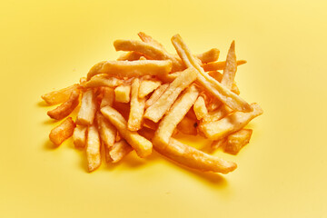  Bunch of french fried potatoes over yellow background