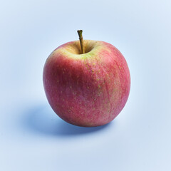  Single red apple fruit over blue background